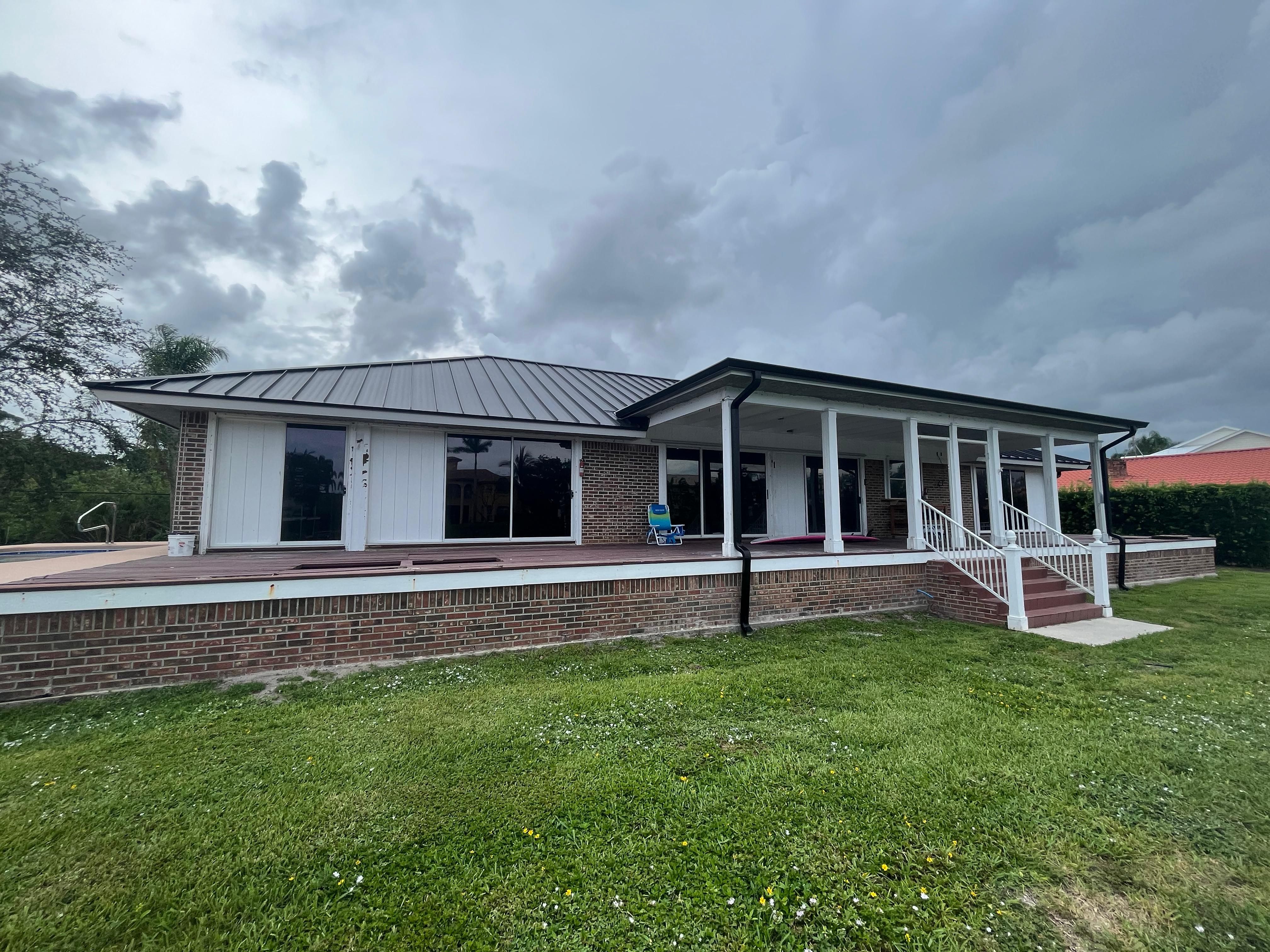 Gutter run installed on a brick home with a standing-seam metal roof