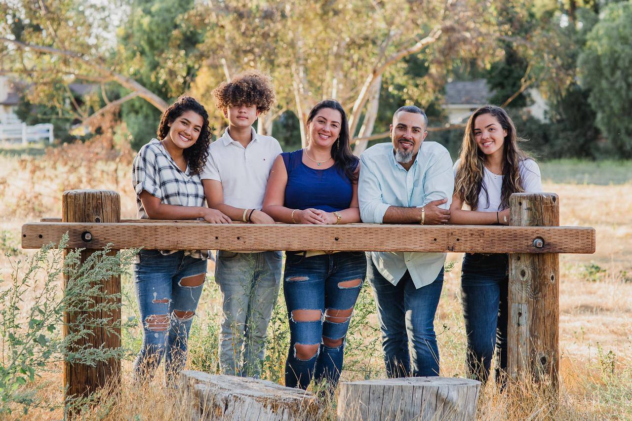 Warren and his family — the owners of Certified Gutters — together for a portrait at golden hour